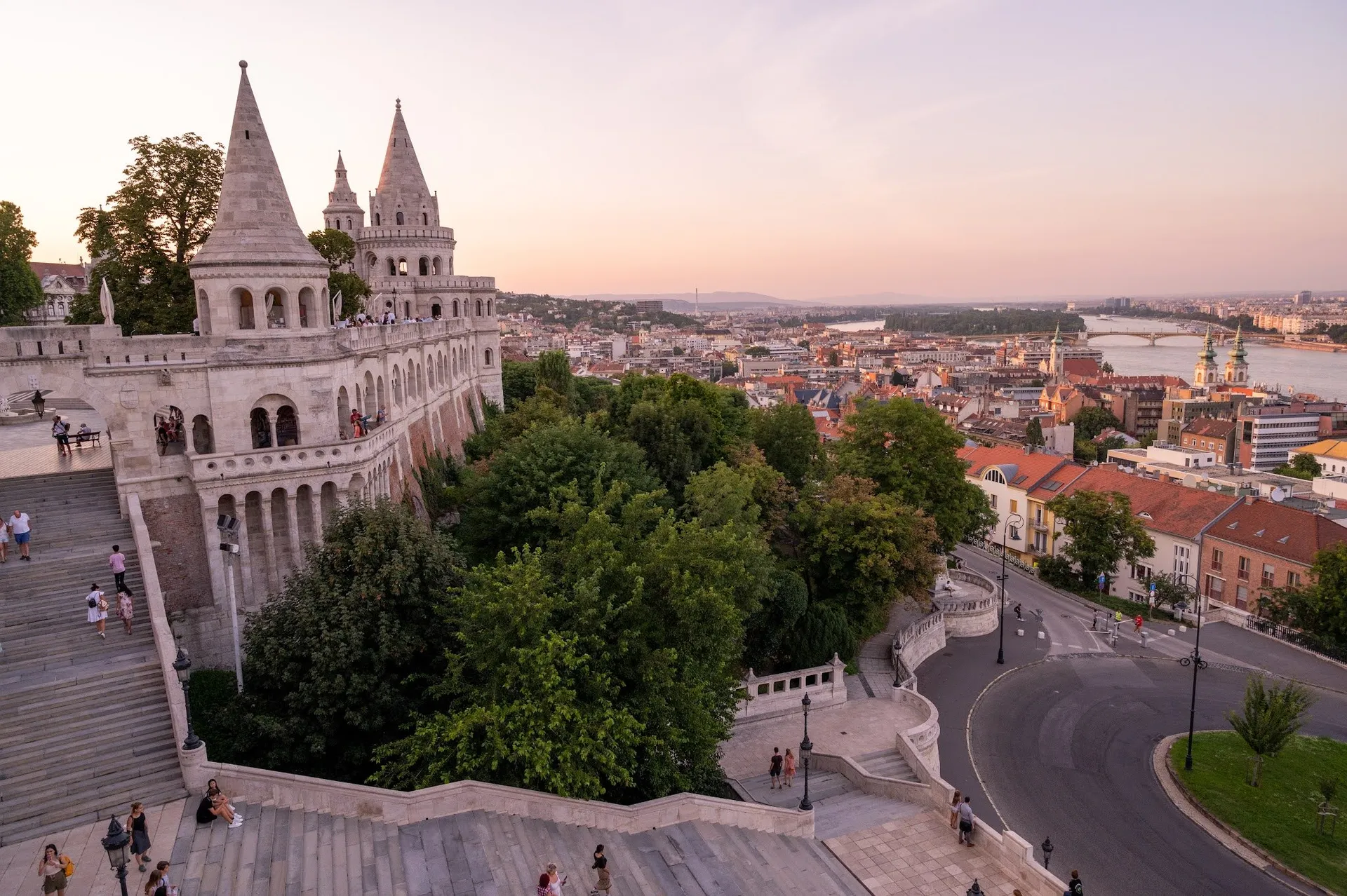 The towers of Fisherman's Bastion with wide staircases, on the right the view over the city to the Danube