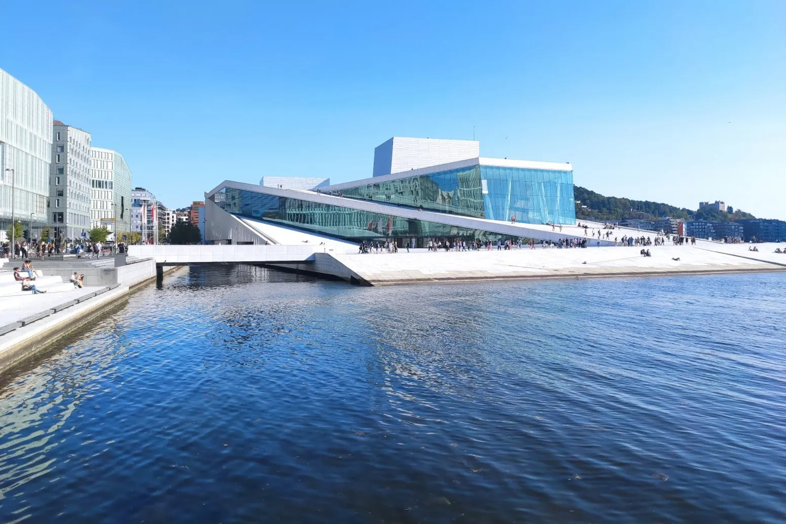 Das Opernhaus von Oslo mit Glasfassade und schrägen weissen Flächen direkt am Wasser