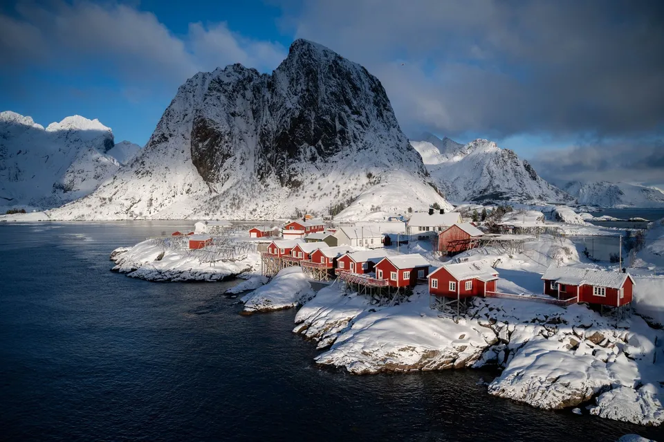 The red rorbuer of Hamnøy on their snow-covered rocks