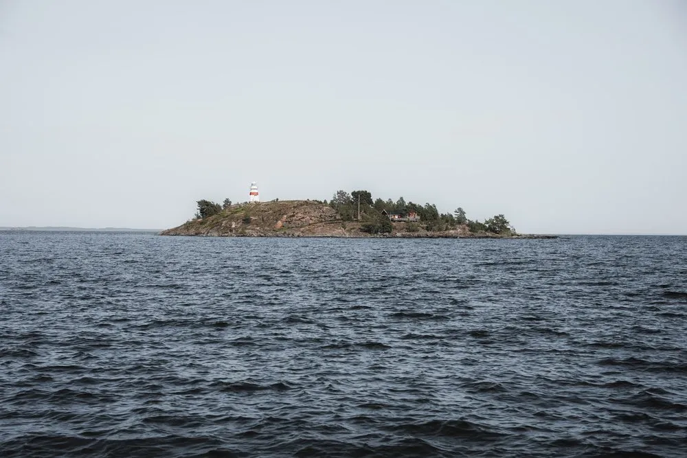 Small island with a red and white lighthouse on Vänern